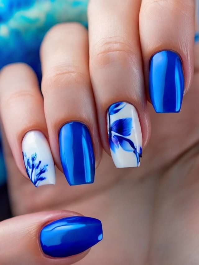 A woman with blue and white nails with floral designs.