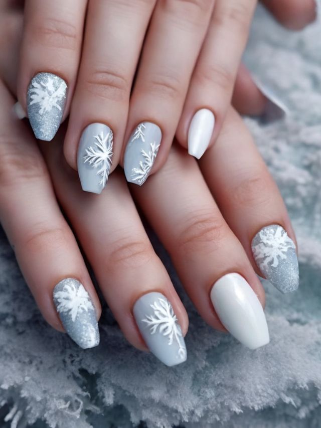 A woman's 35+ hands adorned with snowflakes on their January-themed nail designs.