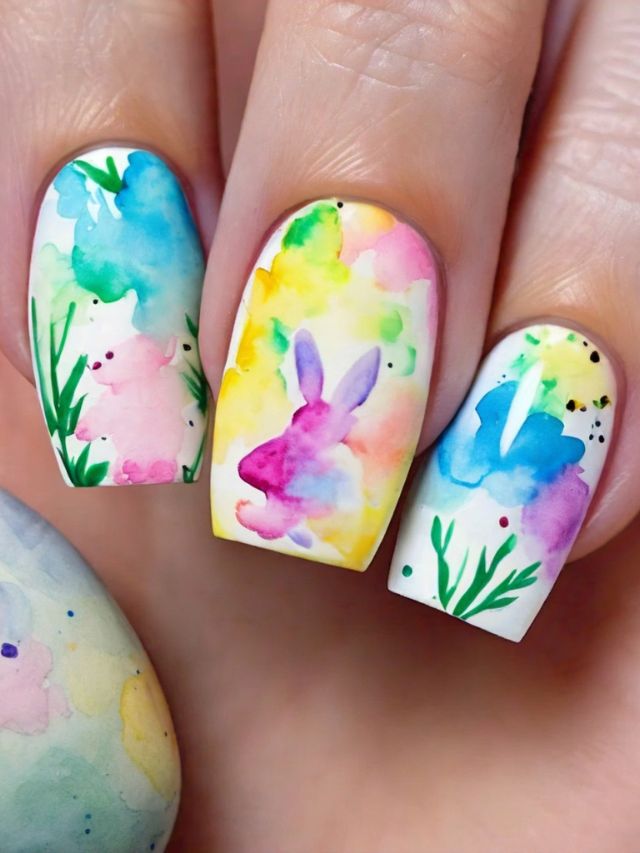 A woman holding up a watercolor nail design with a cute bunny, perfect for Easter.