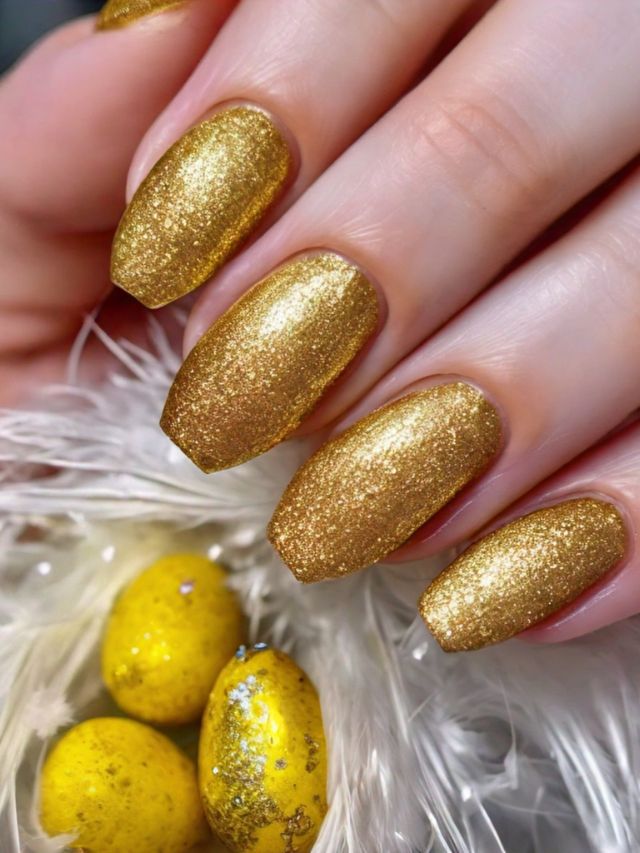 A woman's nails adorned with gold glitter and Easter eggs, showcasing inspiring nail color ideas.