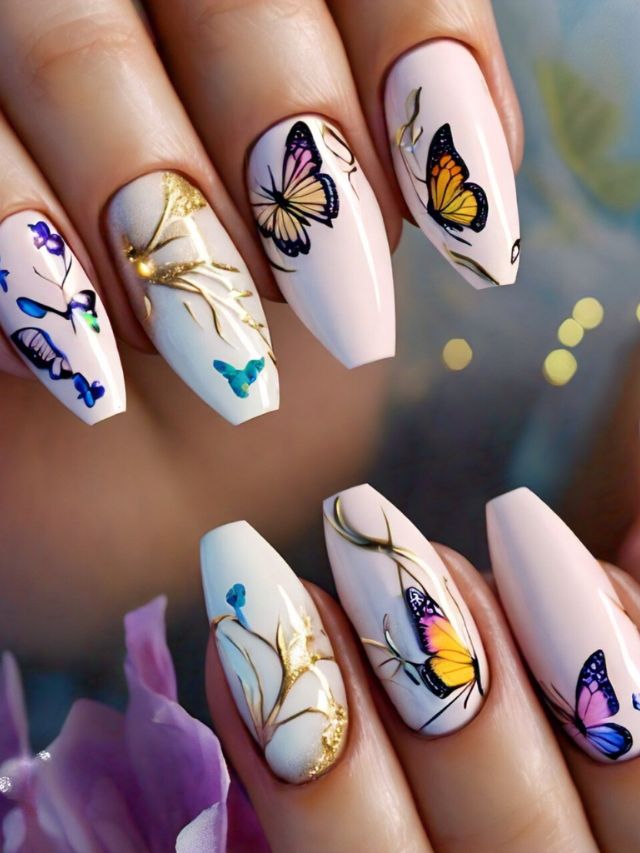 A woman's nails are adorned with Inspiring Designs featuring butterflies and flowers.