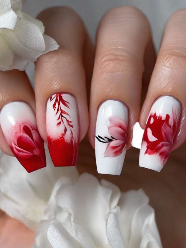A woman's nails are decorated with red and white flowers.