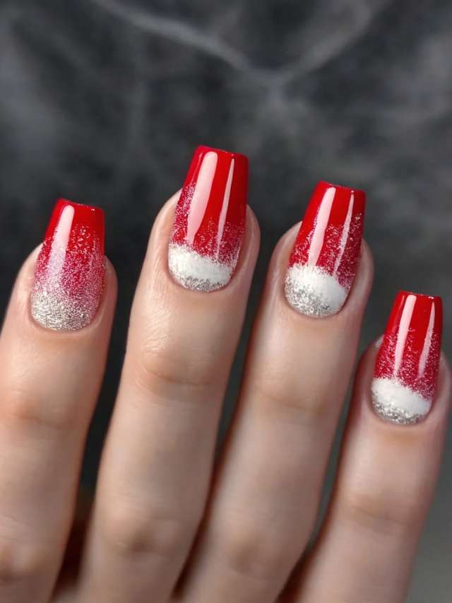 A woman's hand with red and white nails.
