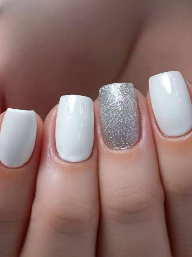 A woman's white nails with silver accents.