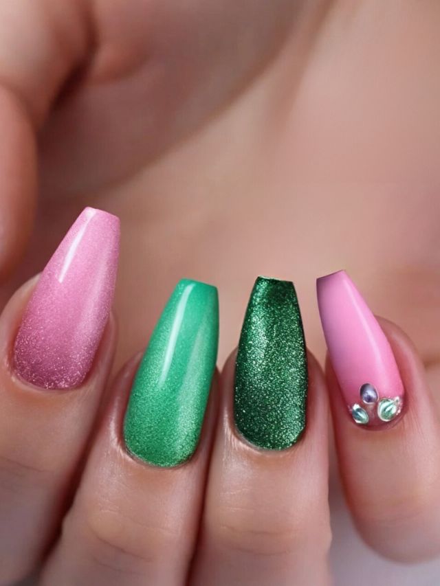 A close up of pink and green nails designs.