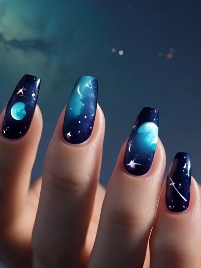 A woman's nails are decorated with cute fall nail designs featuring stars and planets.