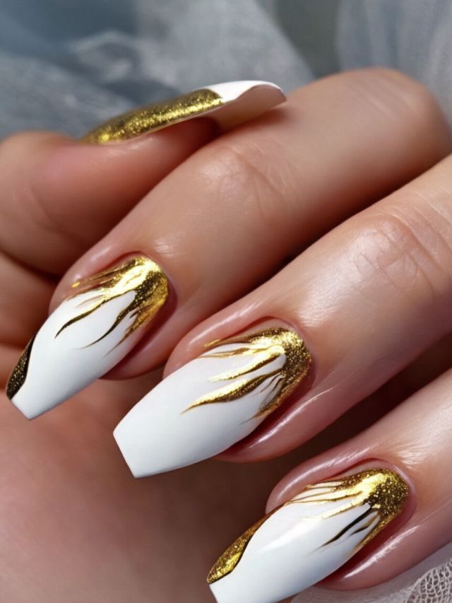 A woman with the best white and gold nail ideas for angelic designs.