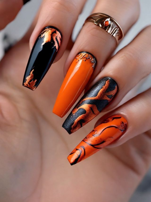 A woman's hand with orange and black nails, showcasing unique nail designs reminiscent of the Ninja Turtle aesthetics.