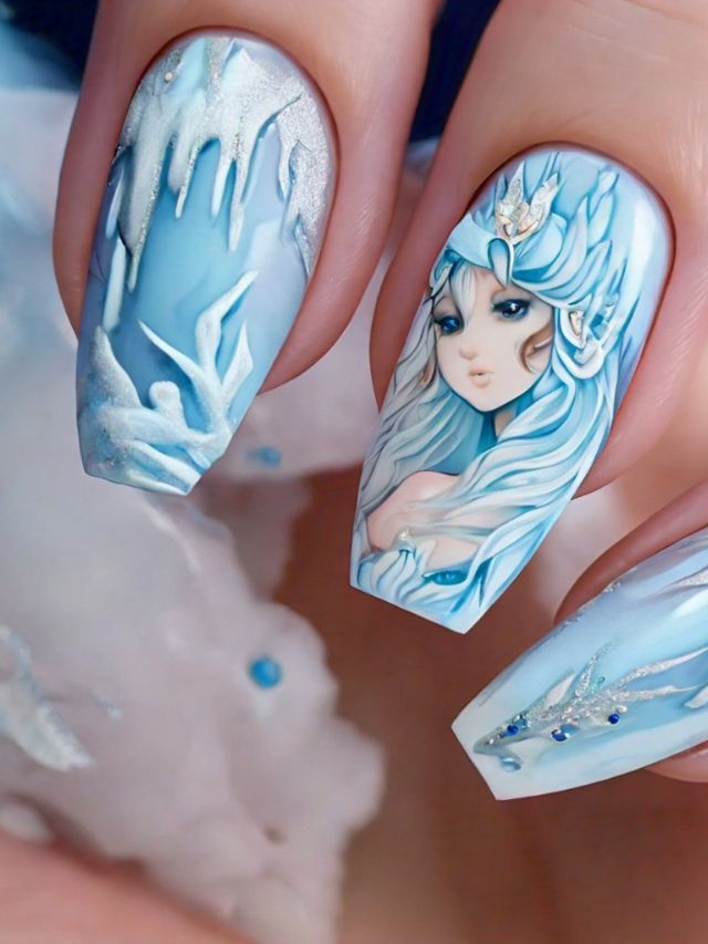 A girl holding up a nail with a blue and white design.