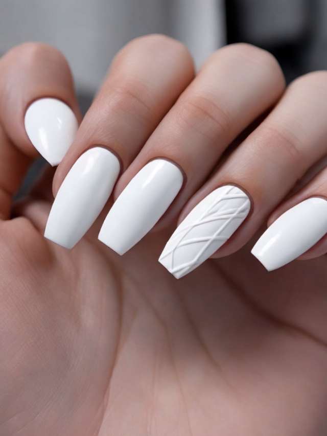 A woman's hand with white nails and a white nail art design.