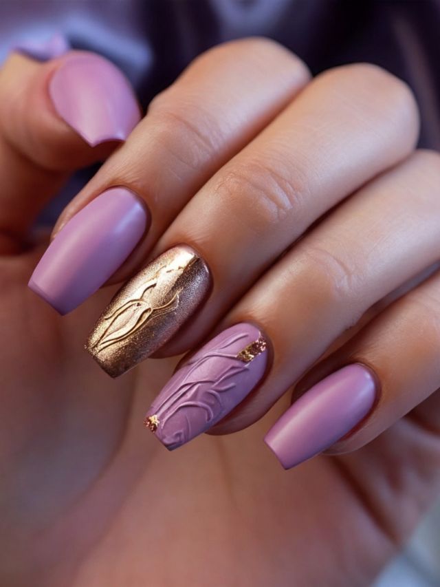 A woman's hand with purple and gold nails.