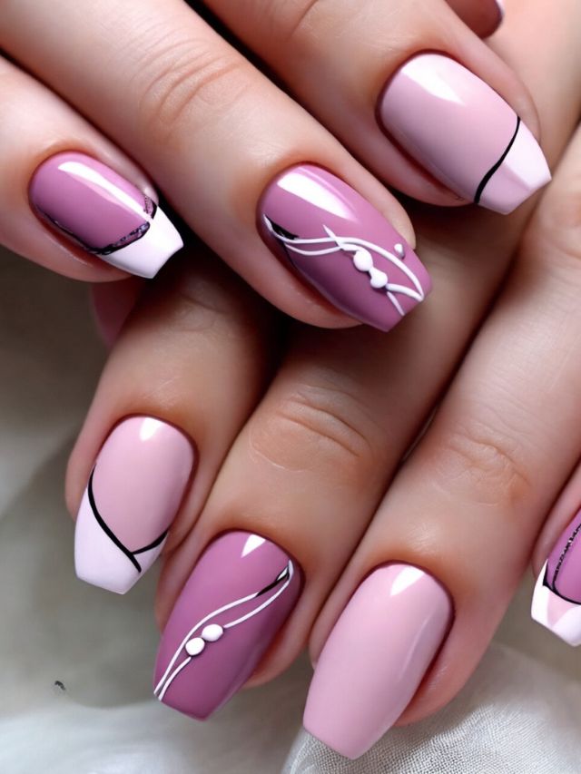 A woman's nails with pink and white designs.