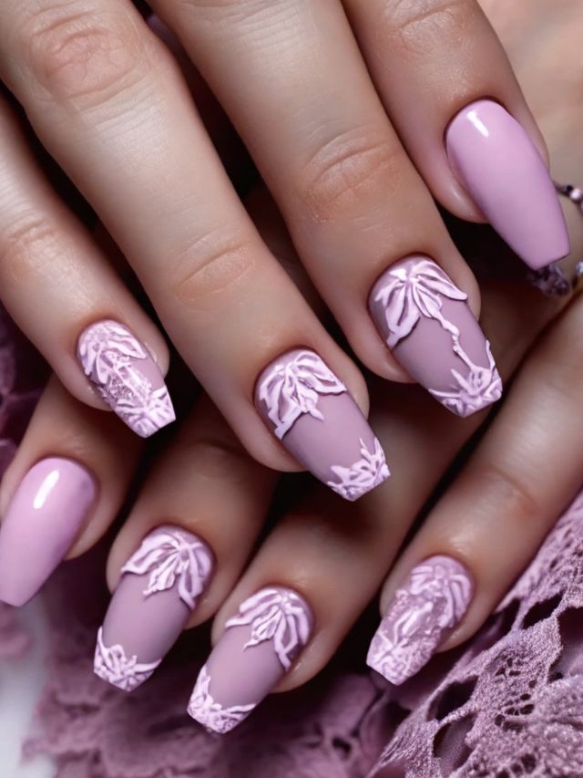 A woman's pink and white nails with lace designs.