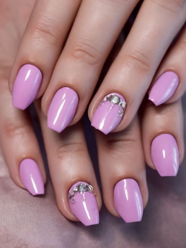 A woman's pink nails with silver accents.