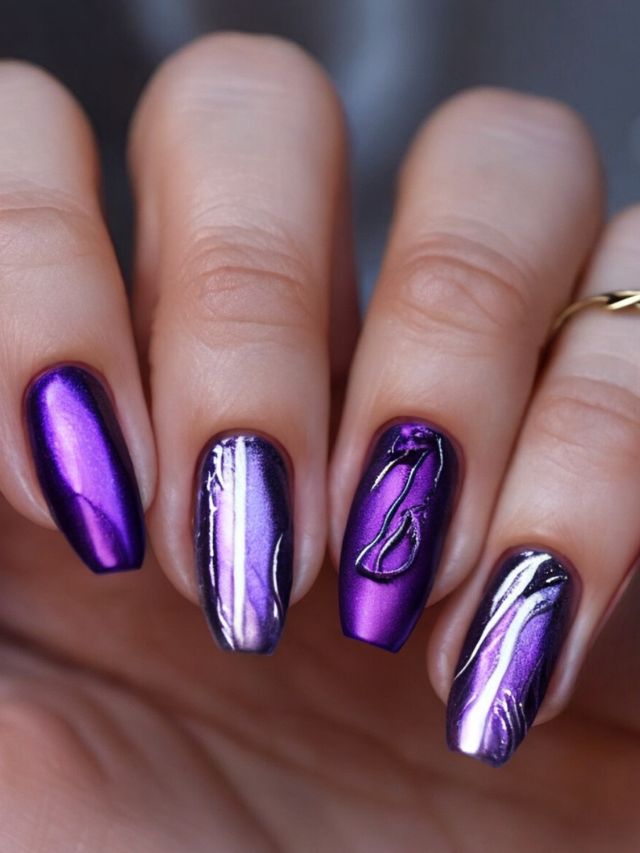 A woman's purple wedding nails with a silver design on them.