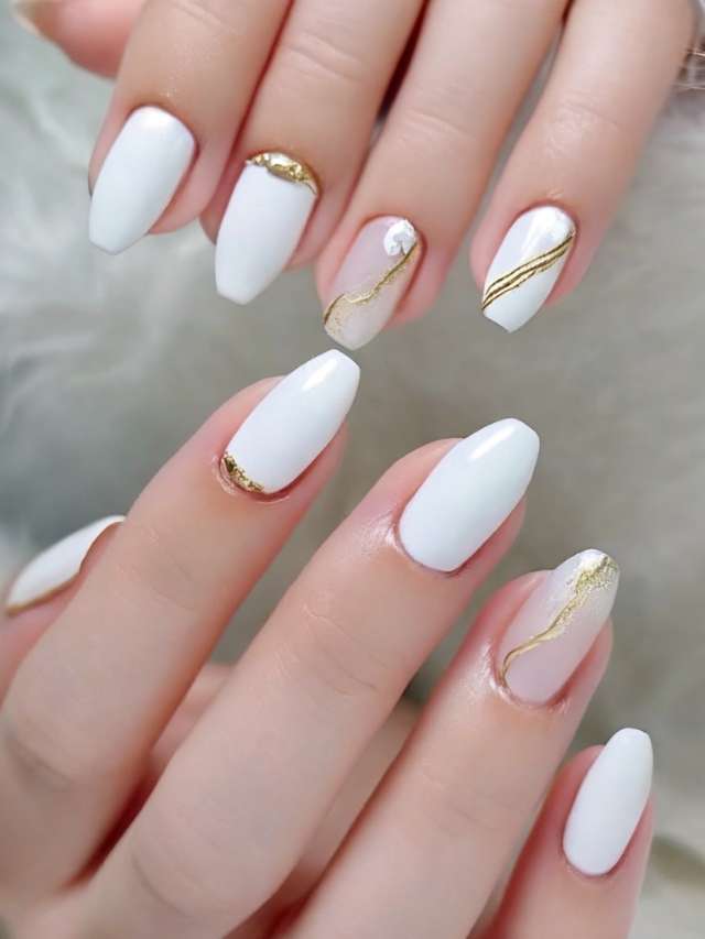 A woman with white nails and gold accents.