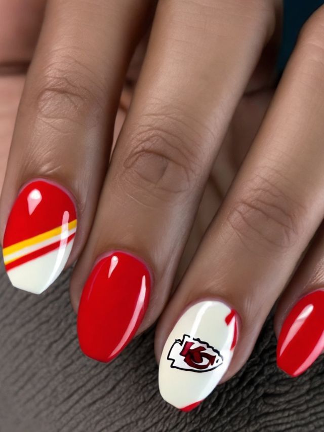 A close up of nails showcasing a Kansas City Chiefs nail design.