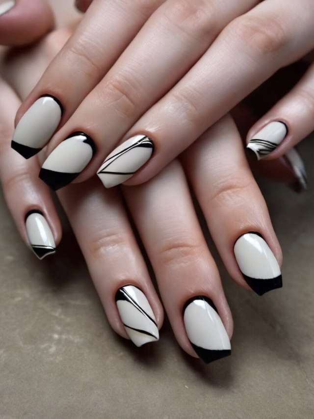 A woman's hands with black and white nail designs.