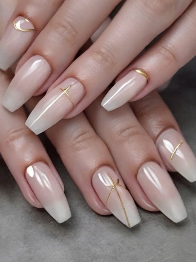 A woman's hands adorned with elegant white and gold nail designs, resembling ethereal angelic creations.