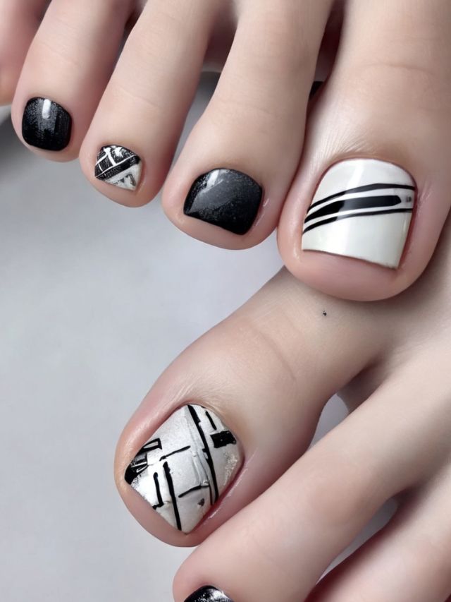A woman's toe nails with black and white designs.