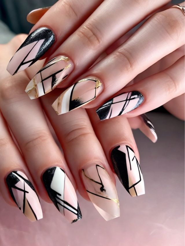 A woman's nails with geometric designs on them.
