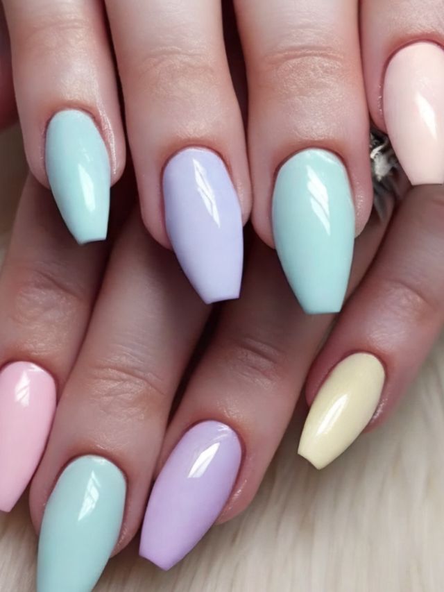 A woman's hands with pastel colored nails.