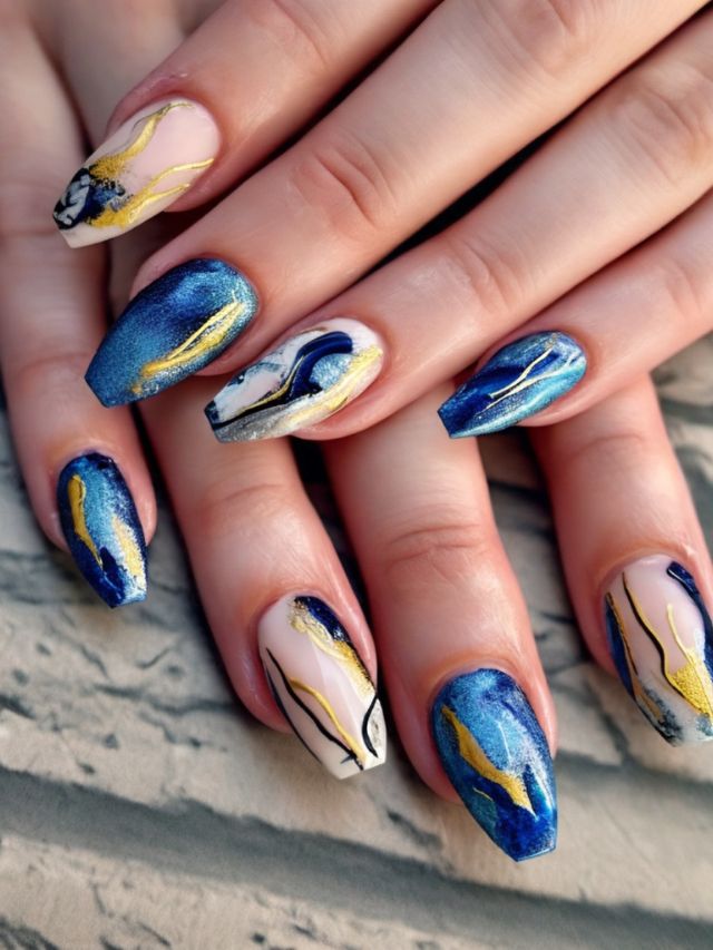 A woman's hands with blue and gold nails.