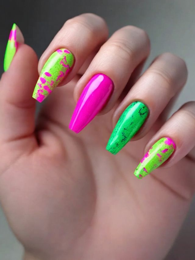 A woman's nails with neon green and pink designs, showcasing playful pink and green nail art.