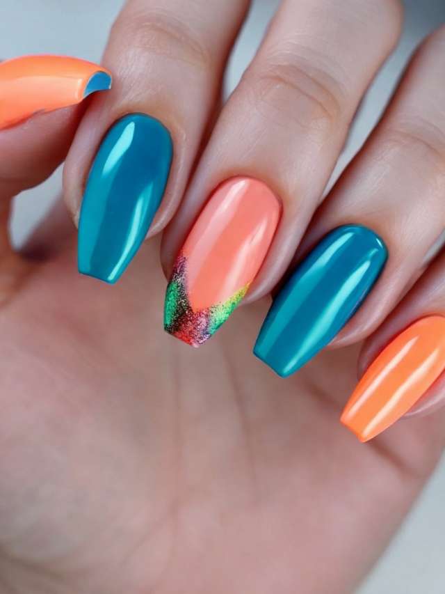 A woman's hand with orange, blue, and green nails.