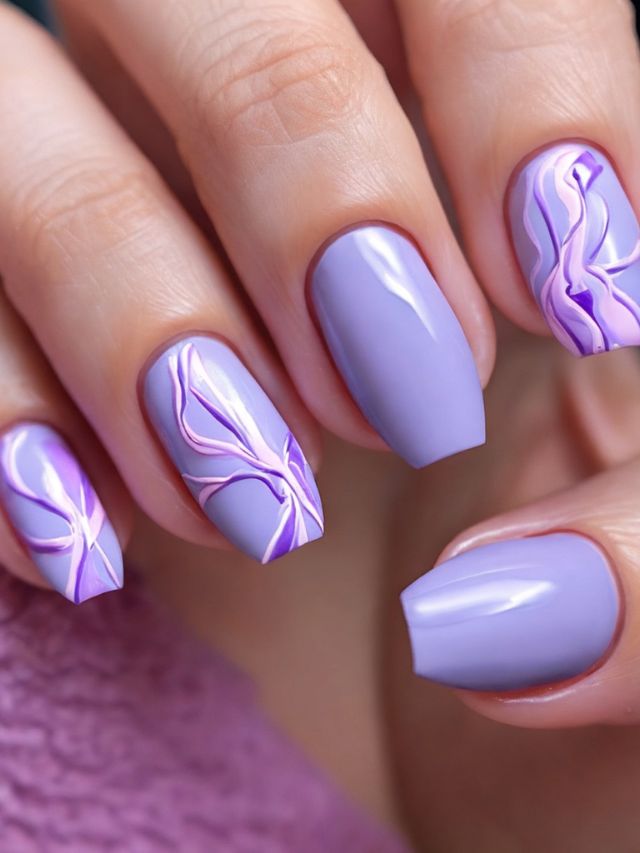 A woman's nails with purple designs, perfect for a wedding.
