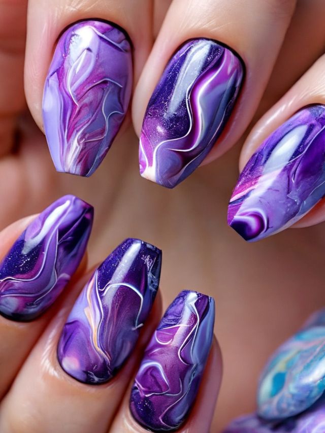A woman's nails with purple and white wedding nail designs.