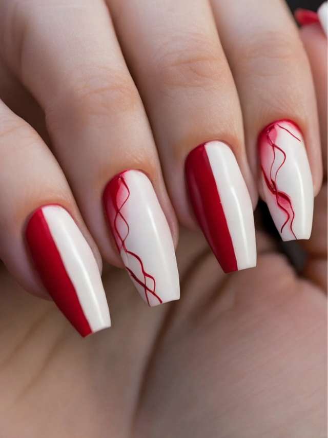 A woman's hand with red and white nail designs.