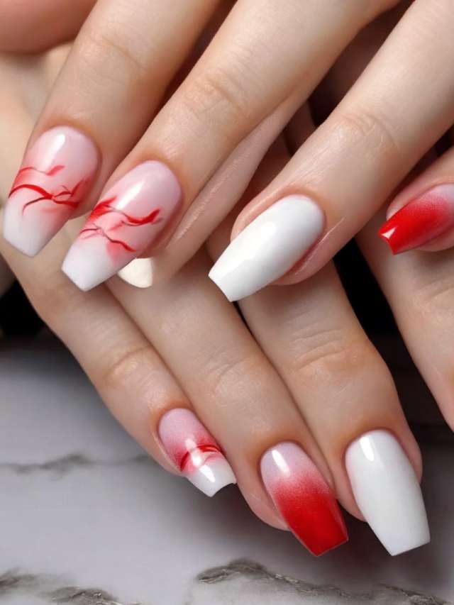 A woman's nails with red and white designs.
