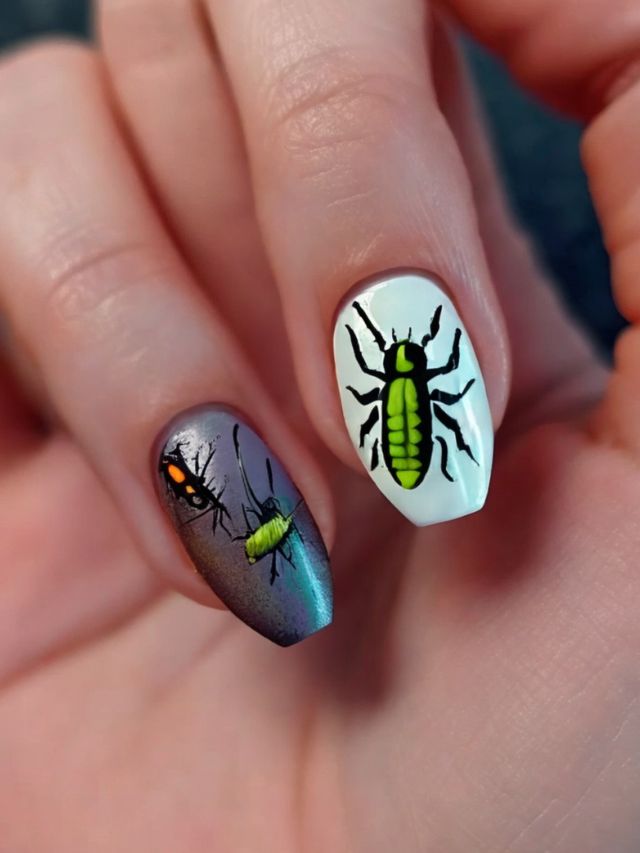 A person holding up a nail with a bug design on it.