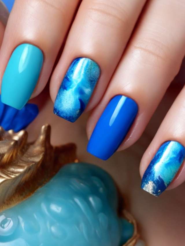 A woman's hand with blue and gold nails.