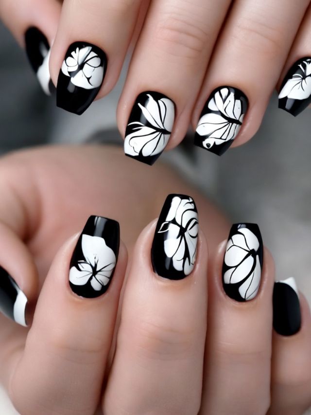 A woman with black and white leaves on her nails.