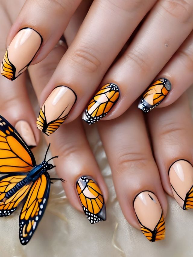 A woman's nails with a butterfly design on them.