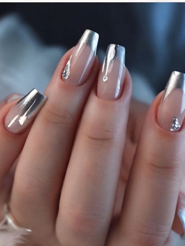 A woman's nails with silver and gold accents.