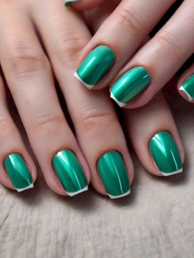 A woman's hands with green and white nails, perfect for St Patrick's Day celebrations and spreading luck.