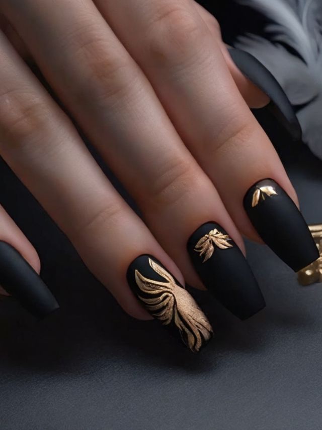 Best black and gold painted nails on a hand.