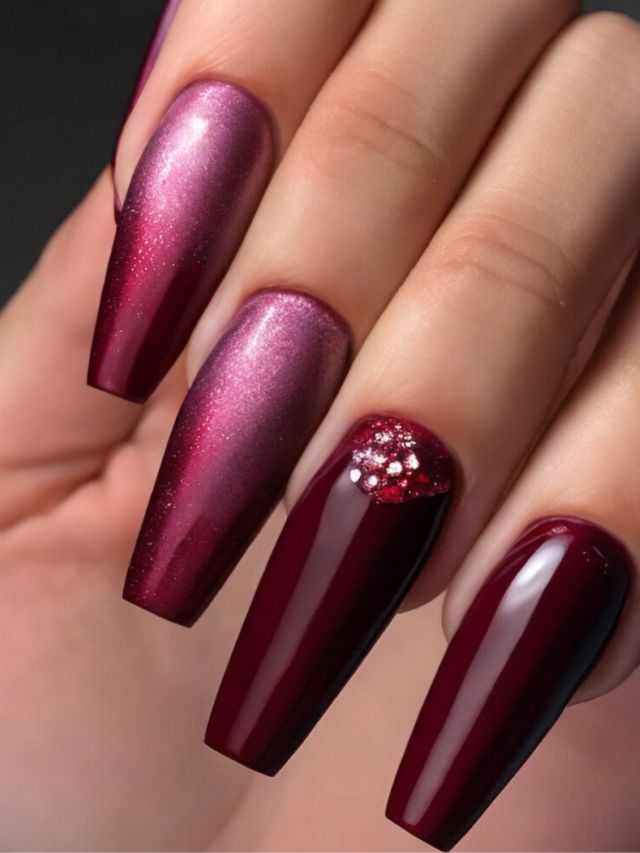 A woman's hand showcases burgundy and purple nails, featuring a trendy fall nail design.
