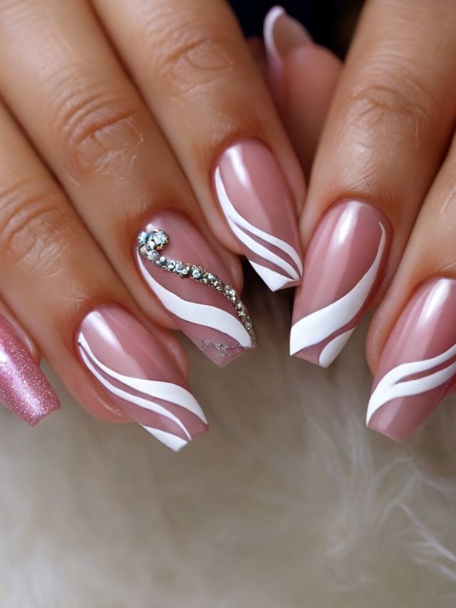 A woman's pink and white nails with a diamond design.