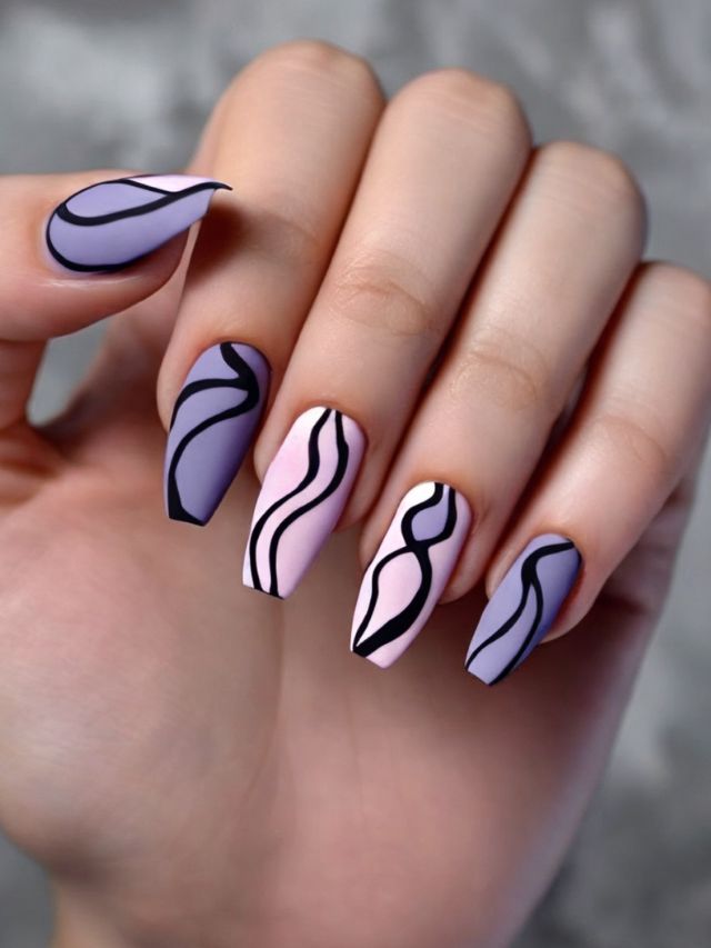 A woman's hand with purple and black nail designs.