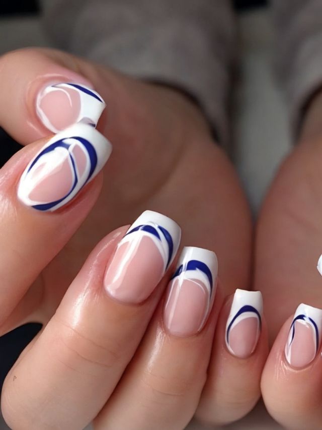 A woman's nails with blue and white designs.