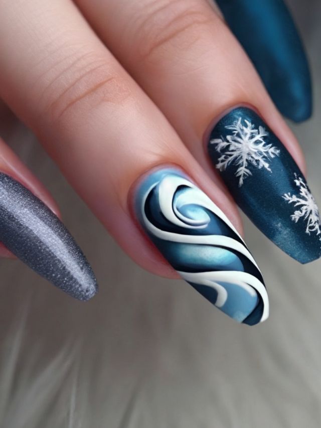 A woman's nails are decorated with blue and white swirls and snowflakes.