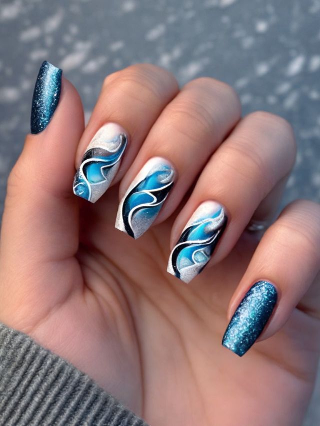 A woman's nails with blue and white designs on them.