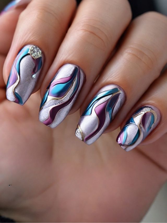 A woman's nails are decorated with purple and blue swirls.