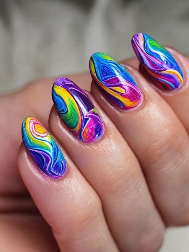 A woman's hand holding a colorful nail design.