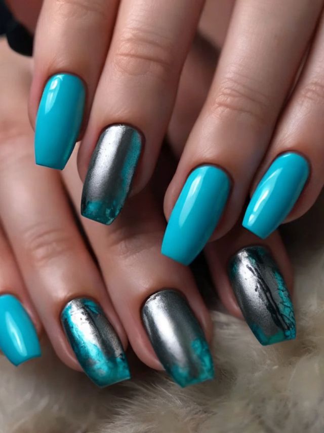 A woman's hand with blue and silver nails.