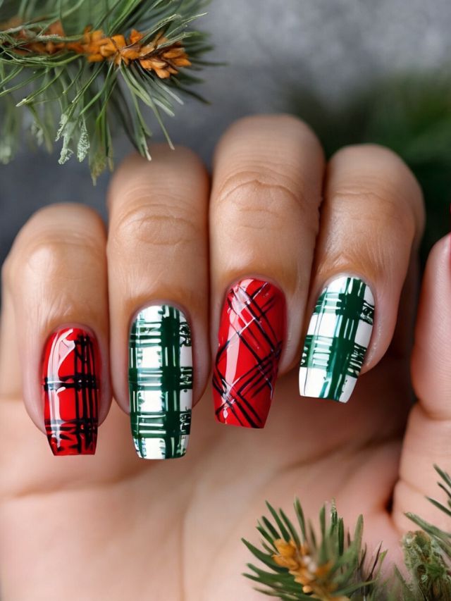 A woman holding up a christmas plaid nail art design.